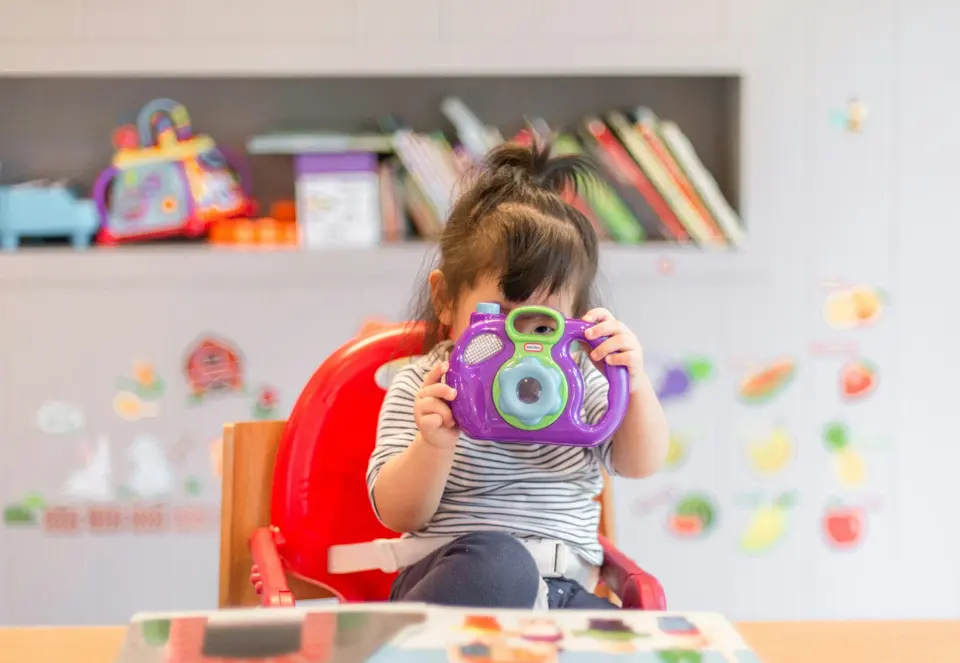 Young child playing in a tidy nursery